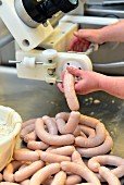 Sausages being made in a butcher's