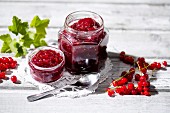 A jar of homemade redcurrant jam with red currants