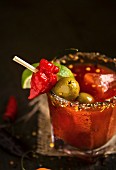 A Bloody Mary with chilli peppers, limes and green olives