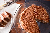 Mocha cake with grated chocolate, sliced