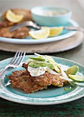 Corn fritters with sour cream and an avocado and onion salad