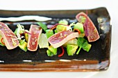 Fried tuna fish slices with grapefruit and avocado