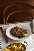 Grilled rib-eye steak with herb sauce and fried potatoes
