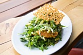 Green salad with orange fillets and a Parmesan crisp