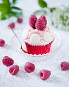 A raspberry cupcake with white chocolate cream