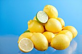 Lemons and limes on a blue surface