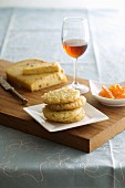 A stack of biscuits, candied oranges and dessert wine