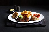Steak and chips served with garlic butter and grilled tomatoes