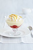 Vanilla pudding with strawberries, cream and caramel sauce