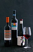 Rotweinglas und drei Flaschen Rotwein aus Spanien