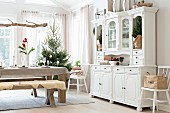 Table set for Christmas, bench and country-house-style dresser