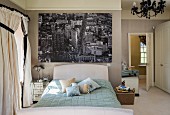 Classic bedroom with large black and white photo mural of New York above bed