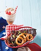 Cola-marinated barbecued spare ribs with deep fried onion rings