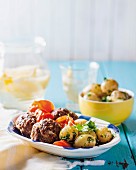Oven-baked meatballs with tomatoes and gremolata potatoes