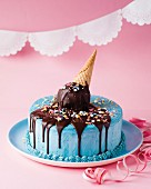 A children's birthday ice cream cake with blue butter cream, an ice cream cone and chocolate