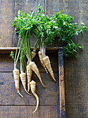 Organic parsnips on a wooden surface