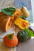Various types of squash, whole and sliced