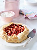 Strawberry pie with cream on a marble table