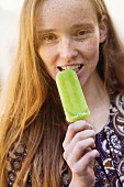 A young woman with a cucumber ice lolly