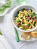Penne with Prosciutto, pea pods and courgettes