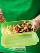 Couscous with vegetables in a Tupperware box