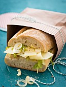 Ciabatta sandwich with cheese, onion and lettuce