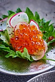 Salmon caviar and radishes on shiso leaves