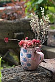 Succulents and thyme planted in mug with retro pattern
