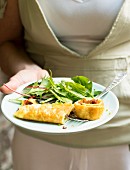 Woman serving omelette with salad in a garden