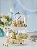 Bread wraps and sandwiches on a cake stand