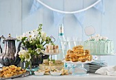 A festive buffet with a large cake and a bottle of champagne