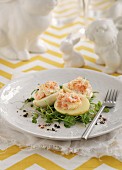 Devilled eggs filled with crab mayonnaise on a bed of cress