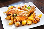 Roast chicken with potatoes, garlic and rosemary