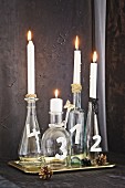 Advent wreath made from festively decorated glass bottles and candles