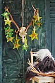 Advent calender hand-crafted from paper stars hung on antlers