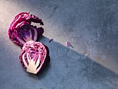 Sliced red cabbage on a grey surface (seen from above)