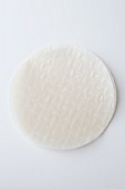 A round sheet of rice paper on a white surface