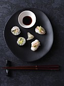 Vegan nigiri and maki sushi with tofu, radishes and cucumber