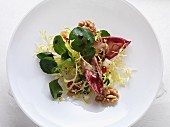 Watercress salad with a cassis dressing and walnuts