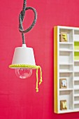 Simple pendant lamp with white lampshade decorated with neon yellow crocheted trim