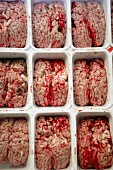 Beef brain with blood in containers at a market