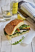 A vegetarian sandwich with grilled vegetables, mozzarella and courgette flowers