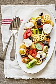 Cold pasta salad with colourful tomatoes and mozzarella