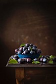 Freshly picked organic plums on a wooden table