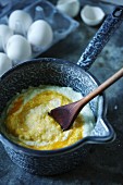 Egg yolk being stirred into semolina pudding