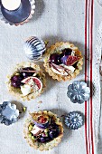 Pistachio and coconut tartlets with black cherries and figs