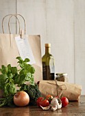 A shopping bag with vegetables and herbs