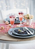 A place setting with chocolate pralines and strawberry champagne