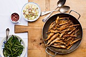 Fried smelts with potato salad and beans