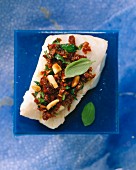 Tomato crust with basil, parsley and pine nuts on fish